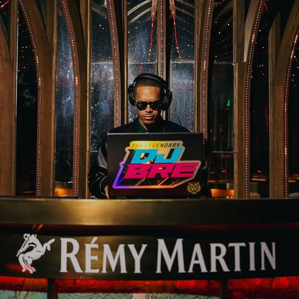 DJ BRE performing with headphones at a Rémy Martin brand event